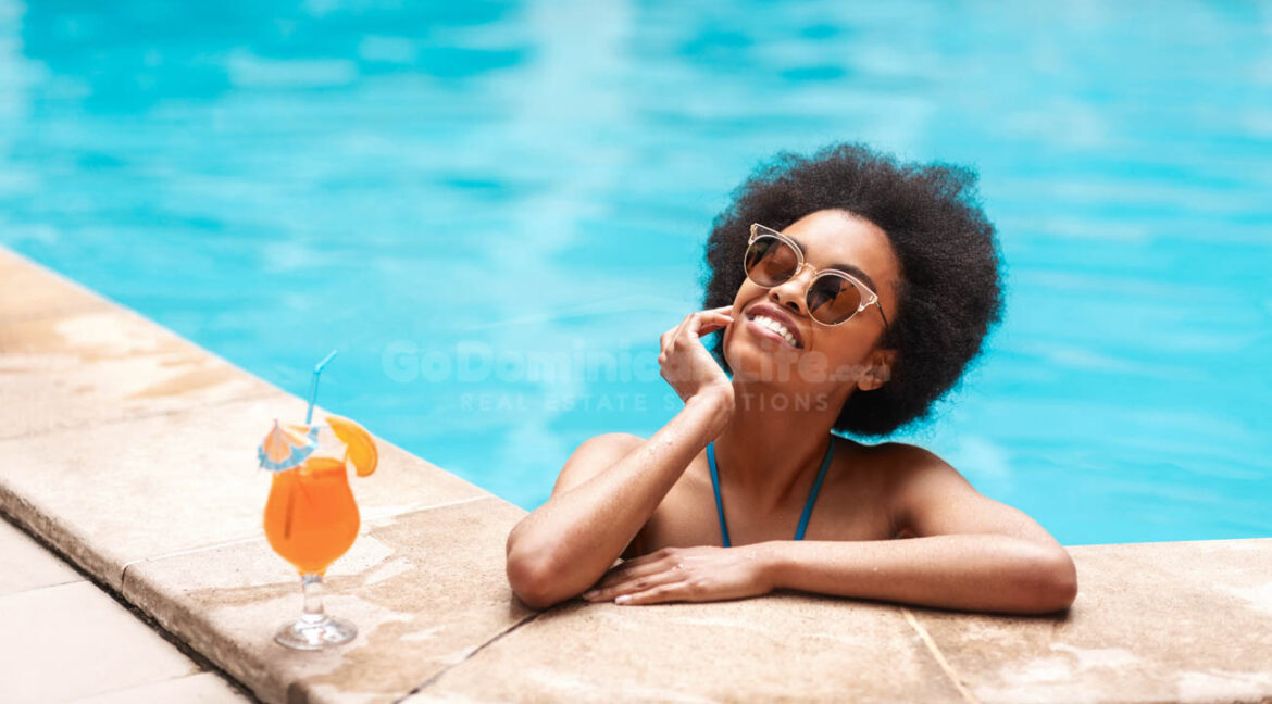 Beautiful,Black,Woman,In,Blue,Bikini,And,Sunlasses,Relaxing,In